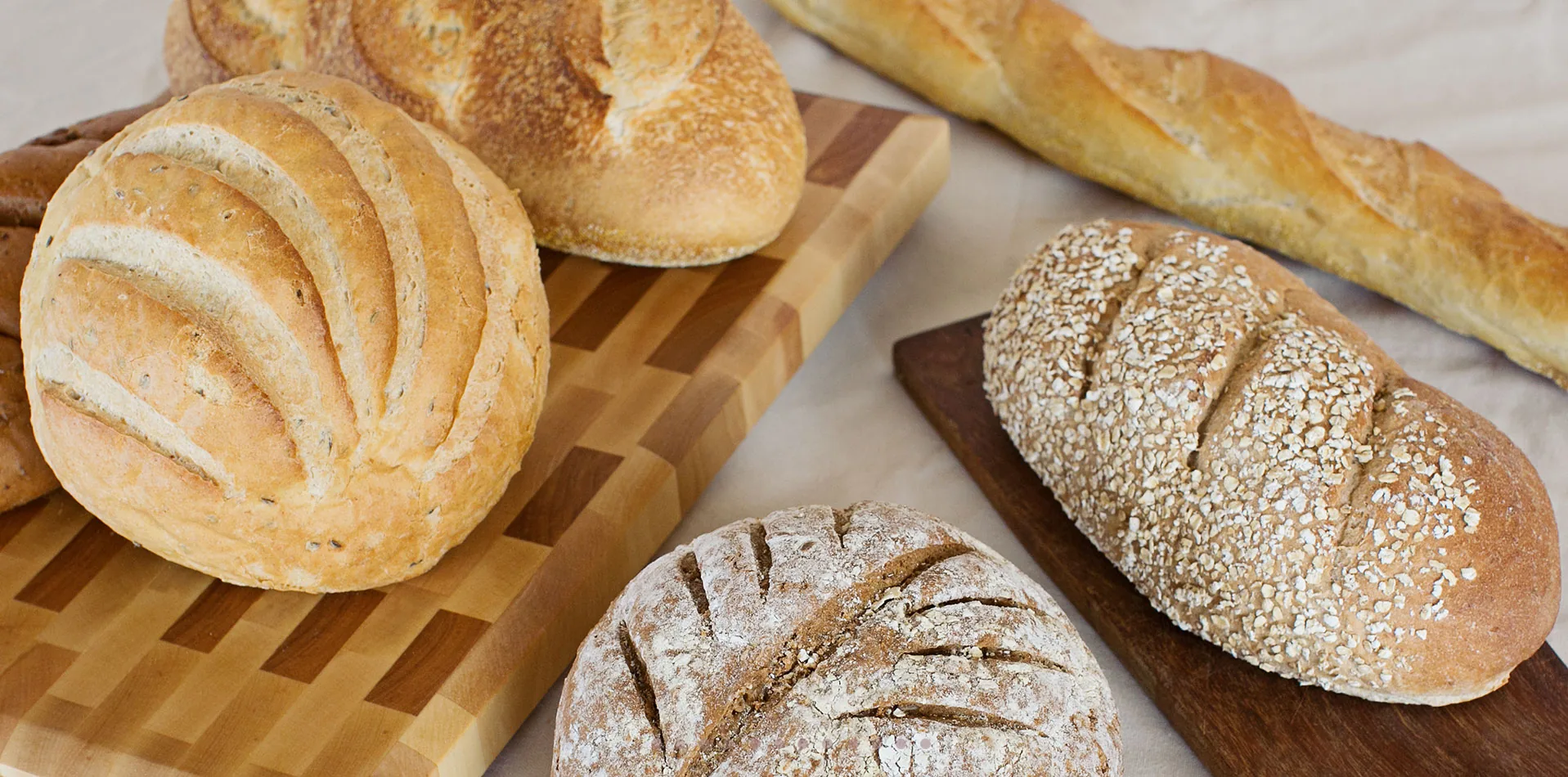 Village Bakehouse breads arranged on a wooden board